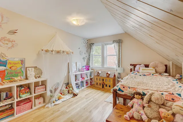 a bedroom with furniture and a wooden floor