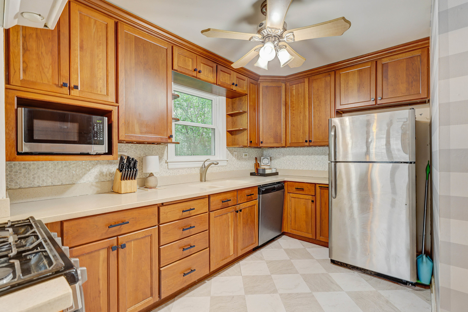 832 Sylviawood Avenue Park Ridge, IL 60068 - Photo 6 of 29 a kitchen with stainless steel appliances granite countertop a refrigerator sink and cabinets