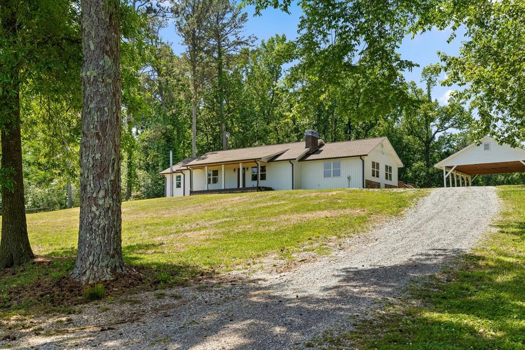 446 Brown Bridge Road Chatsworth, GA 30705 - Photo 30 of 75 a white house with a large tree next to a yard