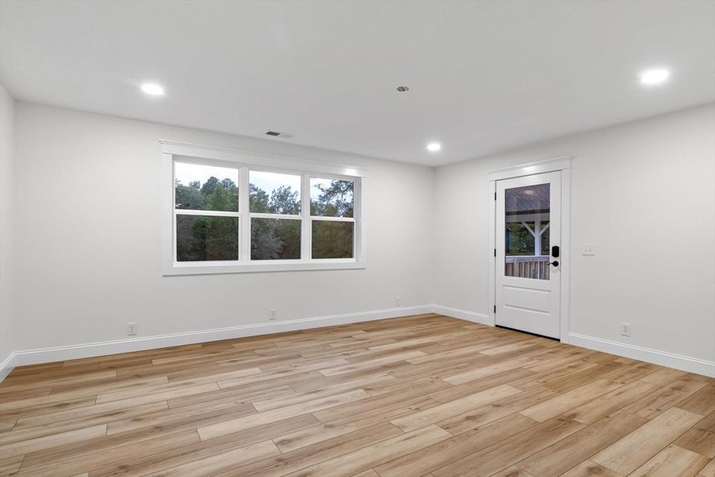 446 Brown Bridge Road Chatsworth, GA 30705 - Photo 46 of 75 a view of an empty room with wooden floor and a window