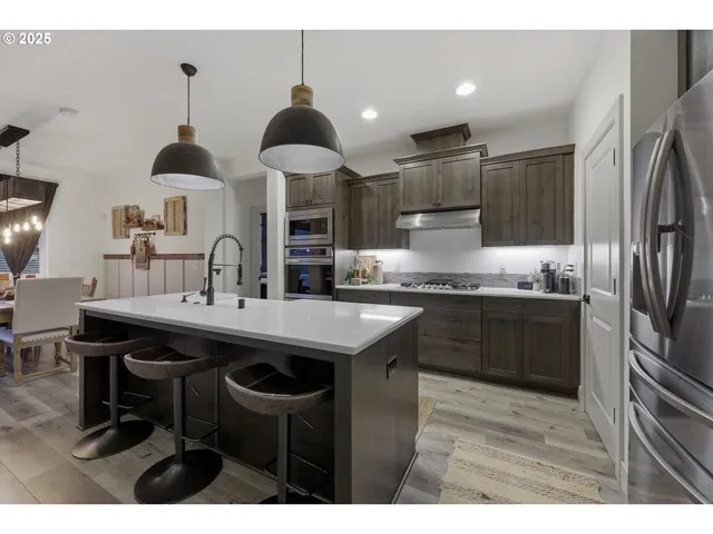 a kitchen with stainless steel appliances a sink stove and refrigerator
