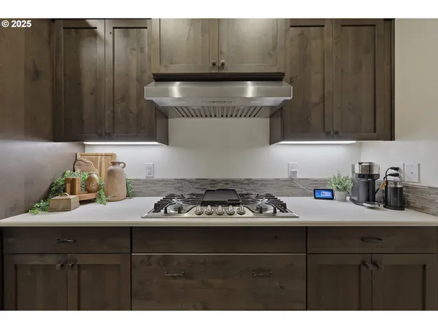 a kitchen with a sink a stove and cabinets