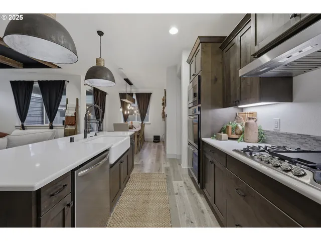 a kitchen with stainless steel appliances a sink stove and refrigerator