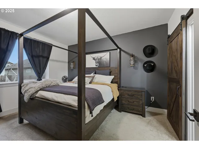 a bedroom with a bed and a window