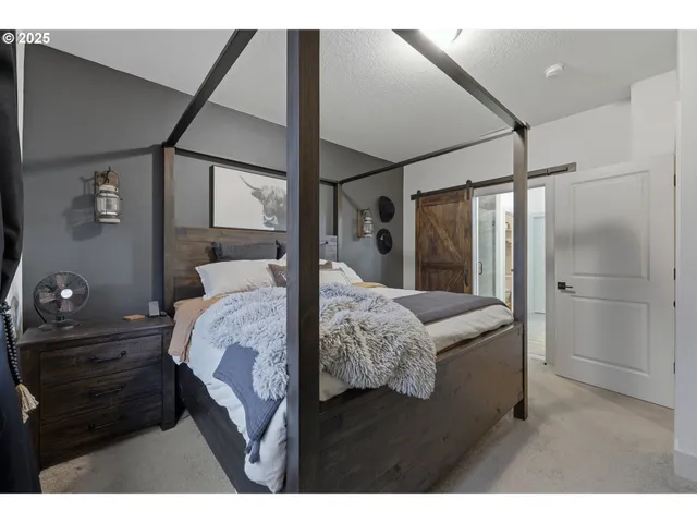 a bedroom with a bed window and a walk in closet