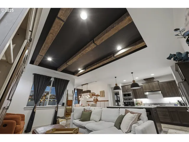 a living room with lots of furniture and kitchen view