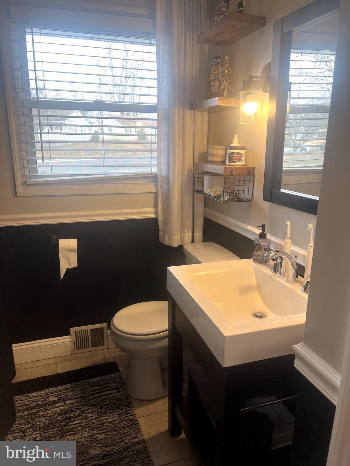 510 Johnson Place Magnolia, NJ 08049 - Photo 13 of 42 a bathroom with a sink toilet and window