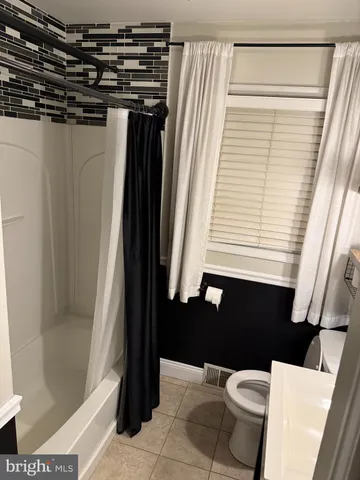 a bathroom with a bathtub and shower