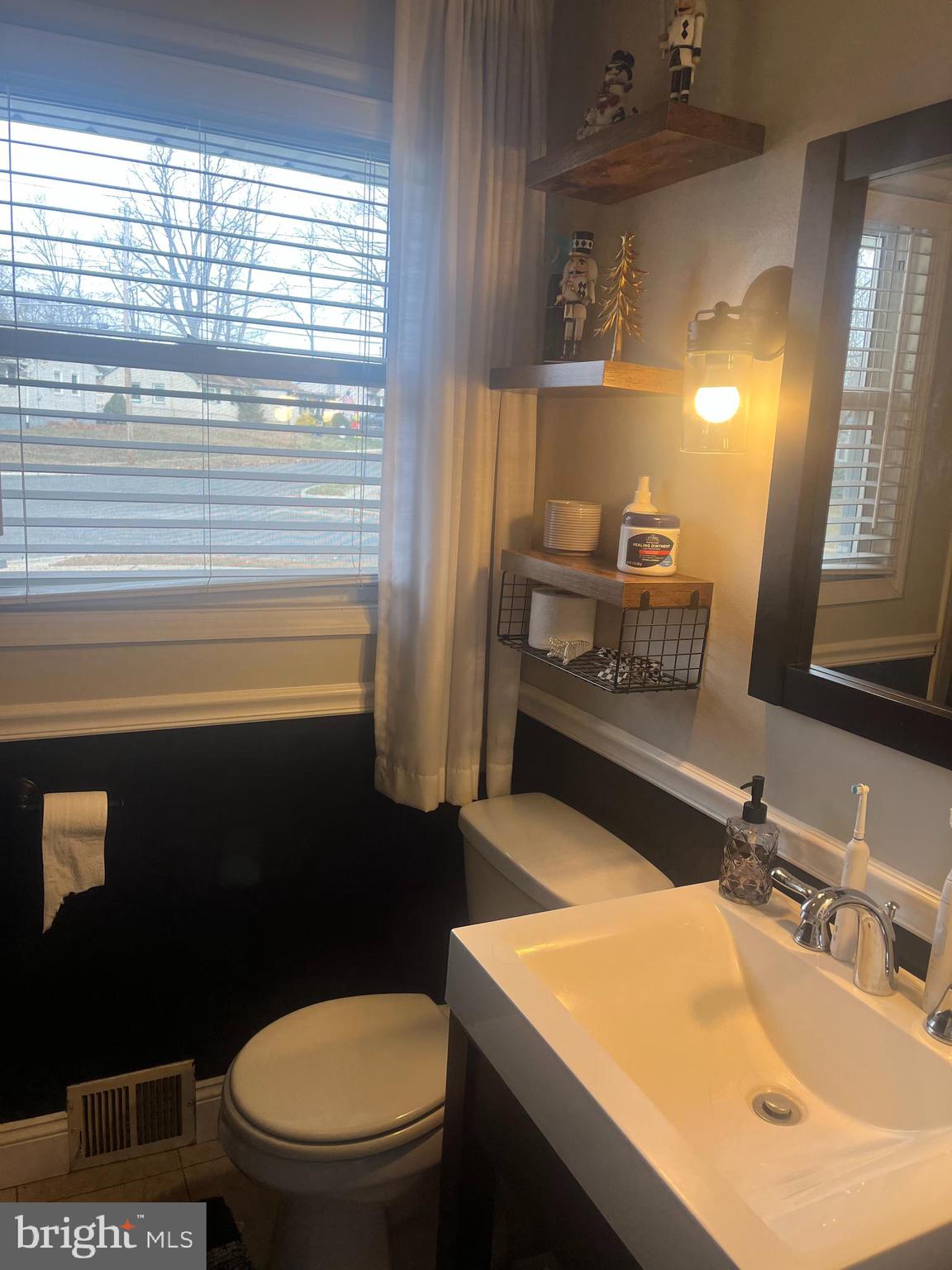 510 Johnson Place Magnolia, NJ 08049 - Photo 16 of 42 a bathroom with a sink a toilet and vanity