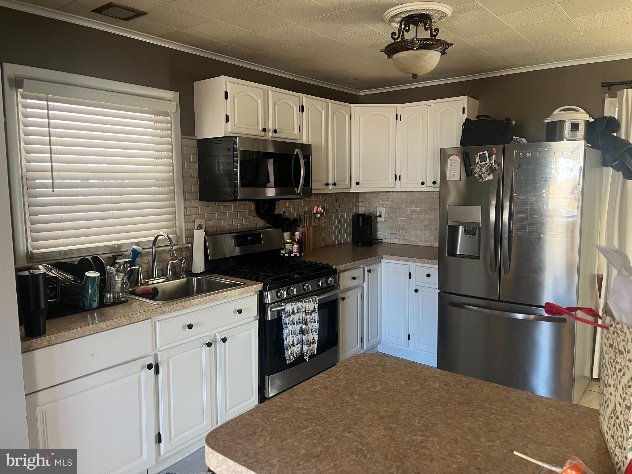 510 Johnson Place Magnolia, NJ 08049 - Photo 19 of 42 a kitchen with a sink stainless steel appliances and cabinets