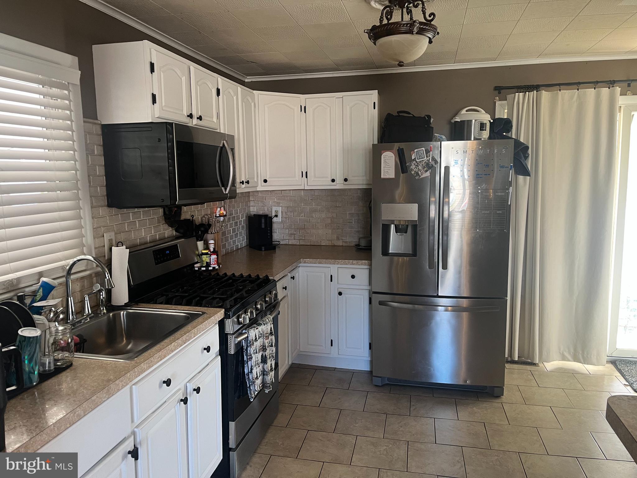 510 Johnson Place Magnolia, NJ 08049 - Photo 20 of 42 a kitchen with a refrigerator and a sink