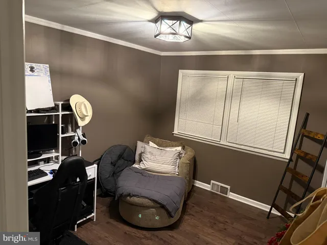 a view of a hallway with closet and chandelier