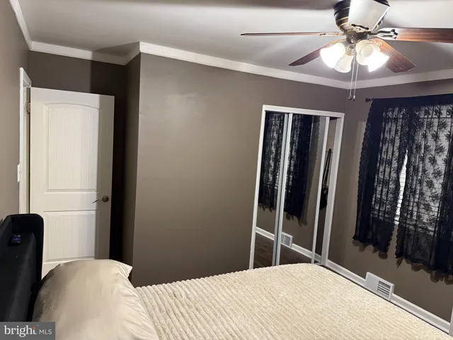 an empty room with wooden floor and entrance