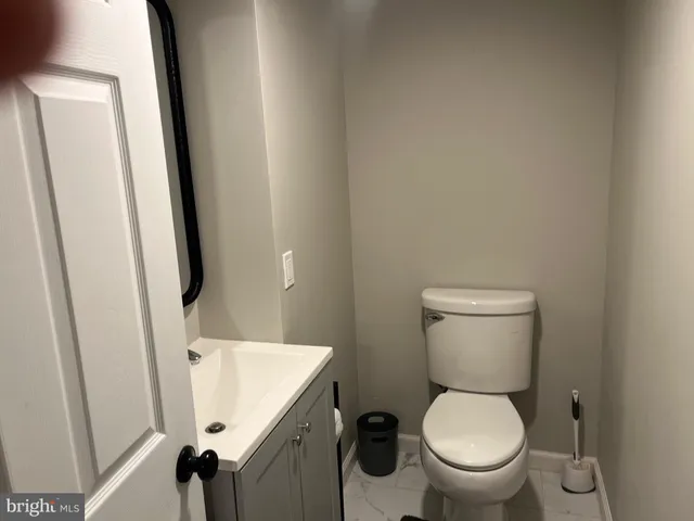 a kitchen with a table chairs and a refrigerator