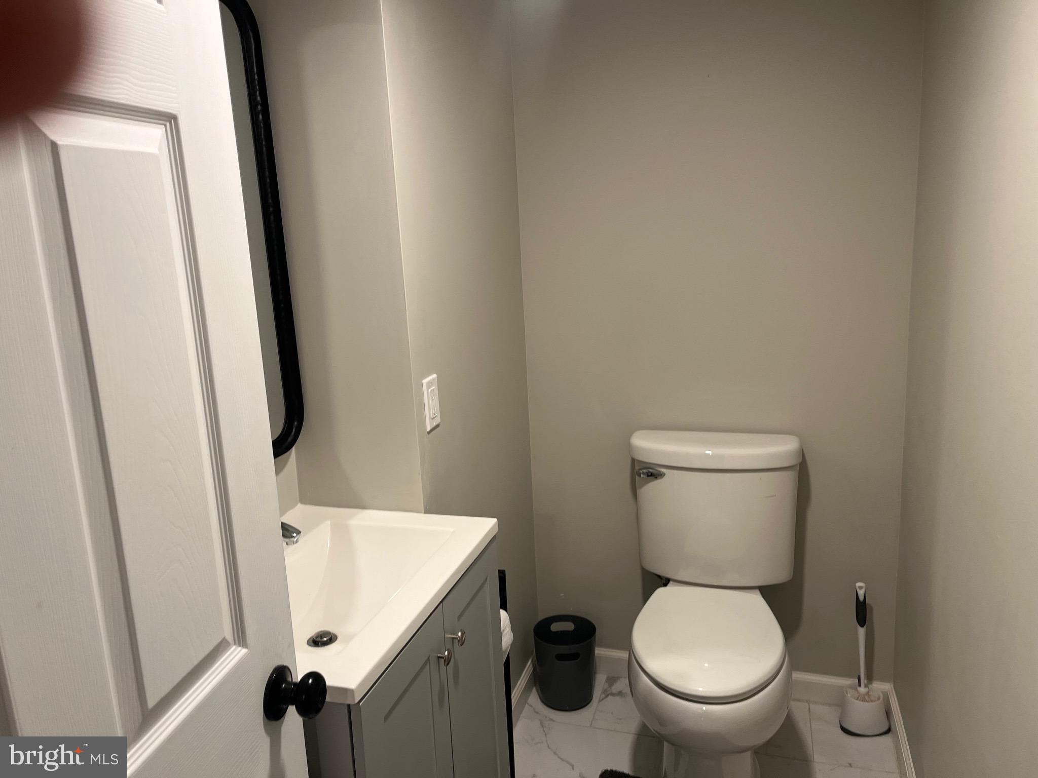 510 Johnson Place Magnolia, NJ 08049 - Photo 31 of 42 a white toilet sitting next to a bathroom sink