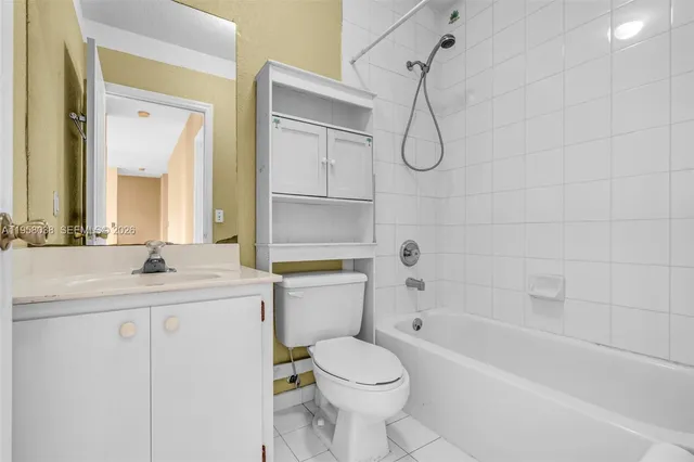 a bathroom with a granite countertop toilet sink and a bathtub