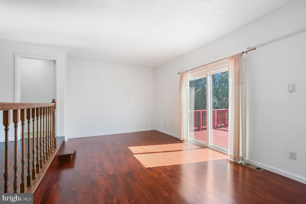 35 Bellfalls Way Nottingham, MD 21236 - Photo 12 of 30 an empty room with wooden floor and windows