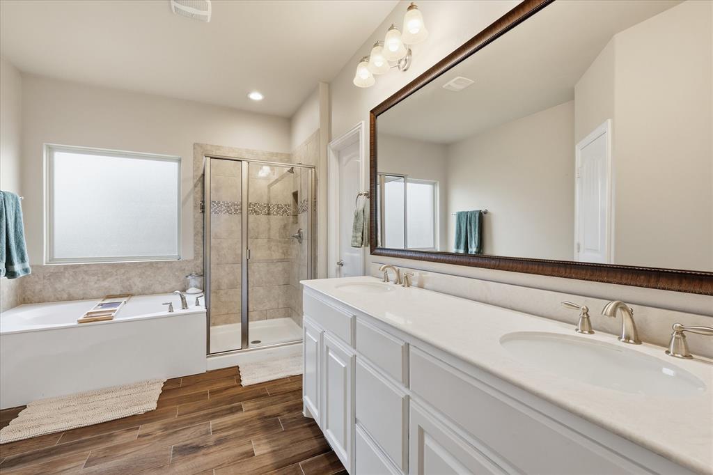 215 Equestrian Road Hickory Creek, TX 75065 - Photo 26 of 36 a spacious bathroom with a bathtub shower sink mirror and vanity