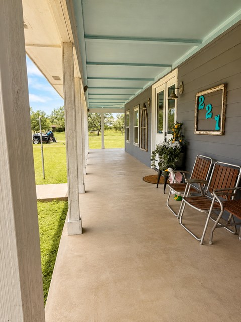 221 Winding Way Road Marble Falls, TX 78654 - Photo 14 of 19 A deep, welcoming porch extends along the home, perfect for enjoying tranquil rural home.