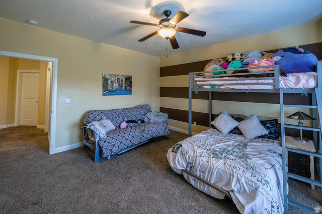 3683 South 2640 West St. George, UT 84790 - Photo 29 of 41 Spacious room featuring neutral carpeting, a ceiling fan with integrated lighting, and a doorway with white trim
