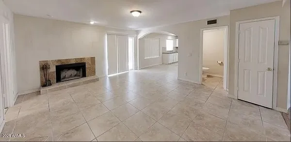 a view of a livingroom with an empty space and a fireplace