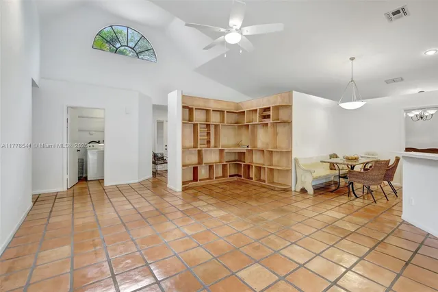 a view of a livingroom with furniture and a chandelier fan
