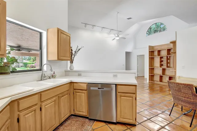 a kitchen with a sink cabinets and window