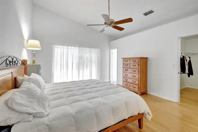 a bedroom with a bed and a large window