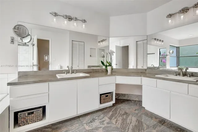 a spacious bathroom with a sink double vanity and a mirror