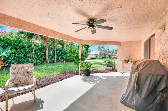 a view of a porch with furniture and a yard