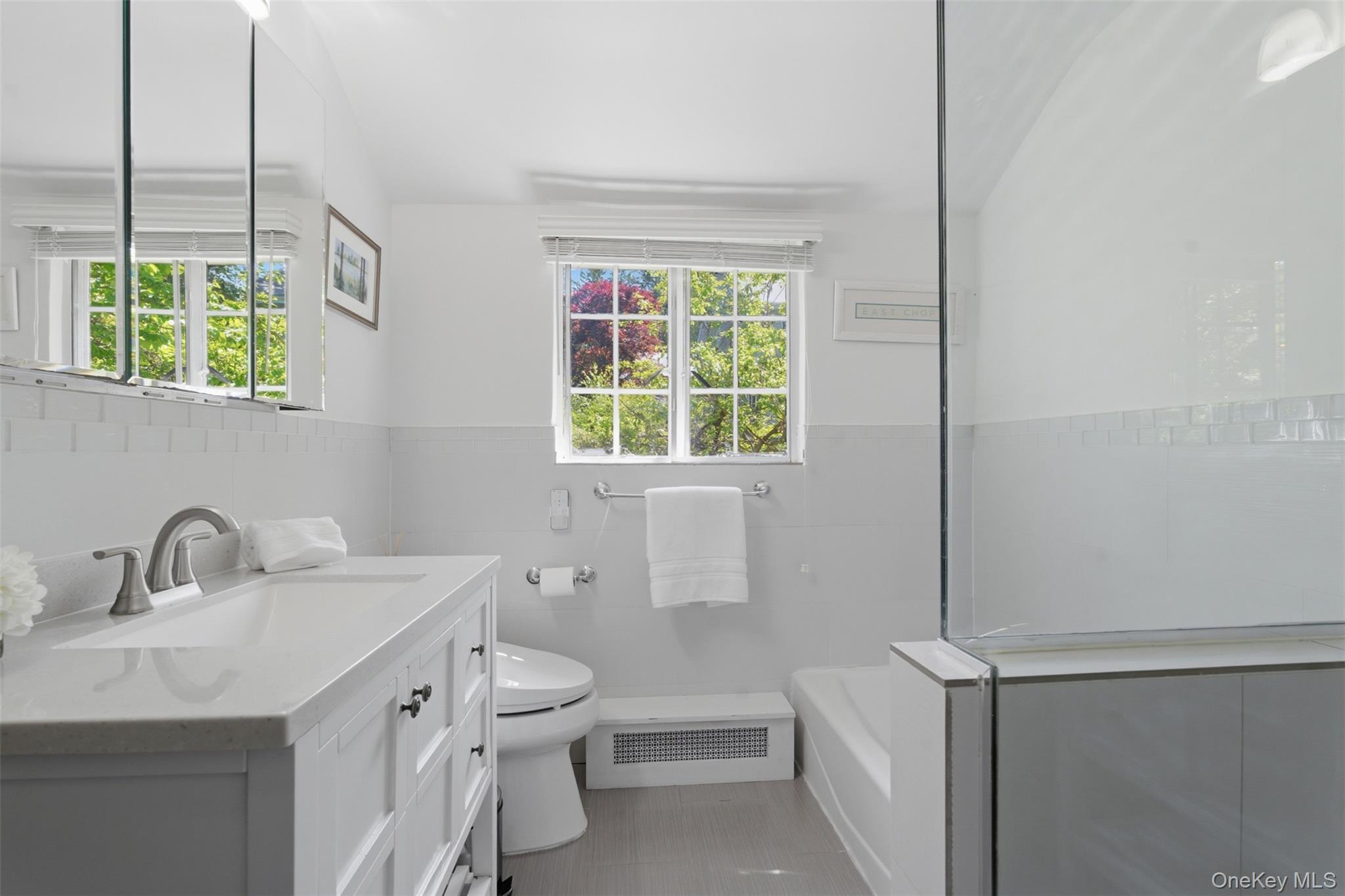 15 Kingsbury Road New Rochelle, NY 10804 - Photo 19 of 30 a bathroom with a sink a toilet and a window