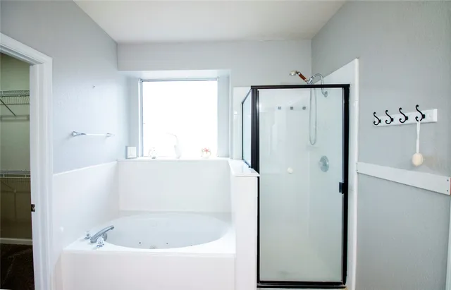 a bathroom with a bathtub and a window