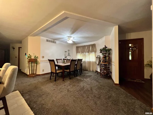 a dining table with chairs and window