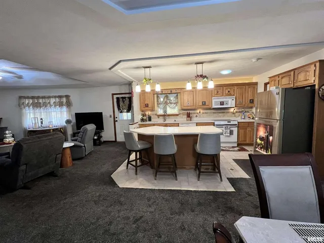 a kitchen with a table chairs sink and cabinets