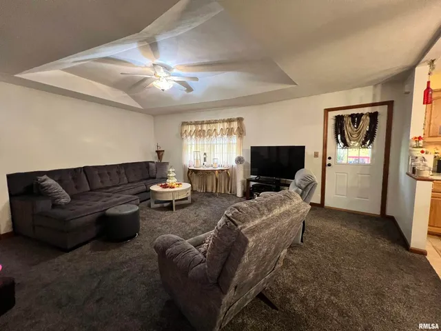 a view of a dining room with furniture and a chandelier