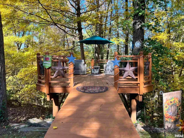 a view of a house with a backyard and a tree
