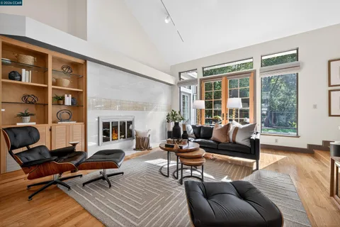 a living room with furniture a rug and a large window