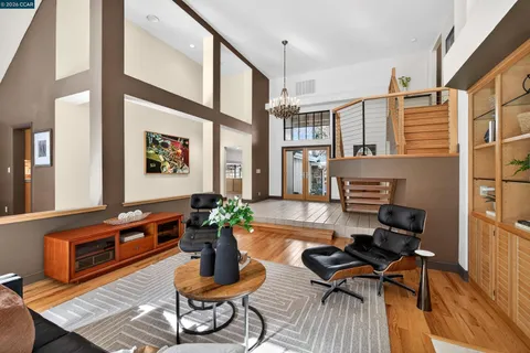 a living room with furniture fireplace and wooden floor