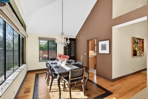 a dining room with furniture and wooden floor