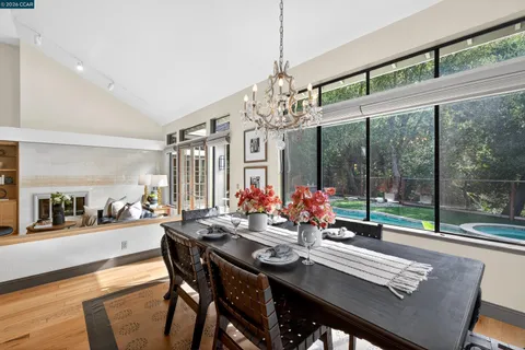 a view of a dining room with furniture wooden floor and chandelier