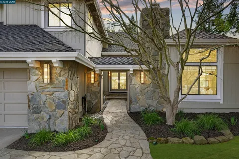 a front view of a house with garden