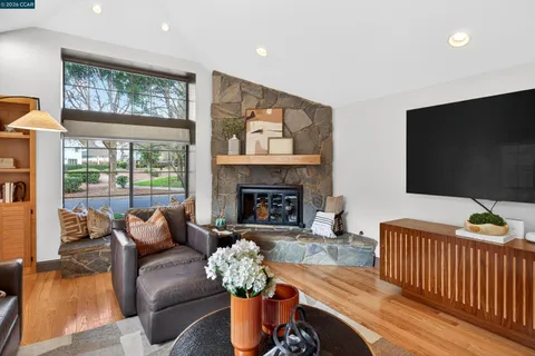 a living room with furniture fireplace and a flat screen tv