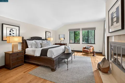 a bedroom with furniture and a large window
