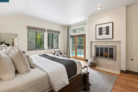 a bedroom with a bed and a fireplace