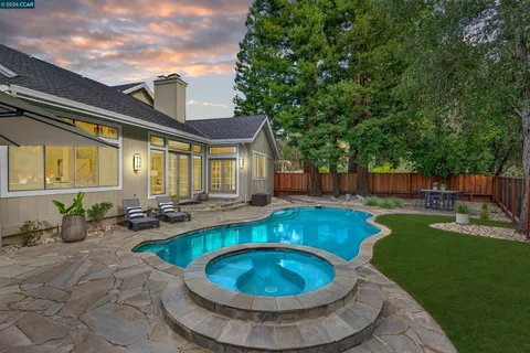 a swimming pool with outdoor seating and yard