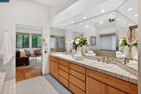 a bathroom with a tub a sink and a glass door shower