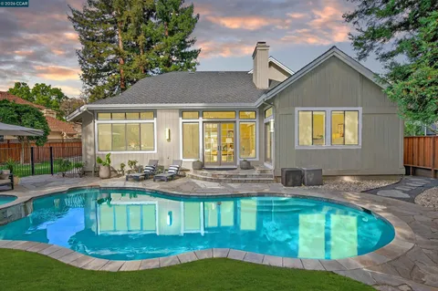 a front view of house with yard and outdoor seating