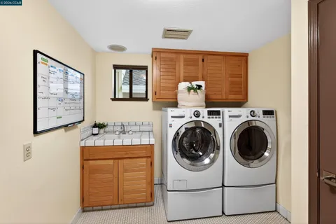 a view of a house with backyard sitting area and swimming pool