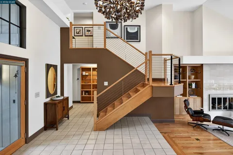 a view of a livingroom with furniture and staircase