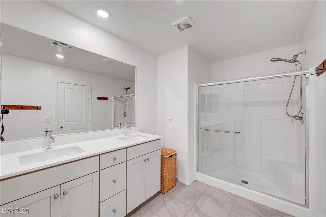3637 Modico Lane Henderson, NV 89044 - Photo 44 of 62 Bathroom with a shower stall and double vanity